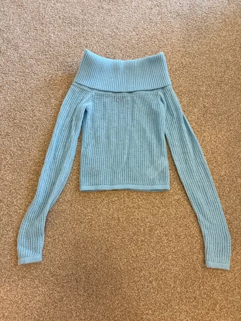 light blue off-shoulder knit jumper, photographed flat at home
